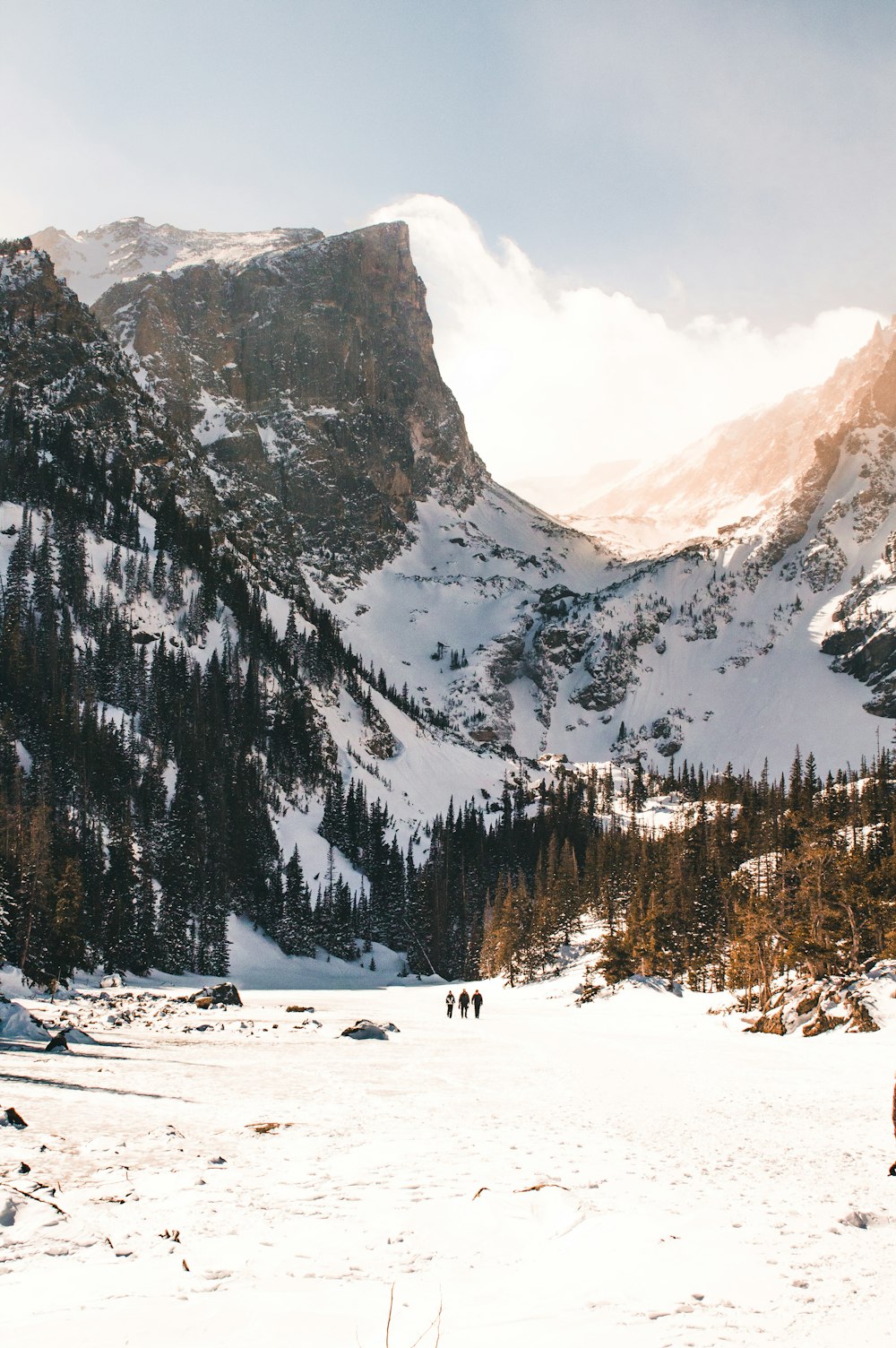 a man standing on top of a snow covered mountain