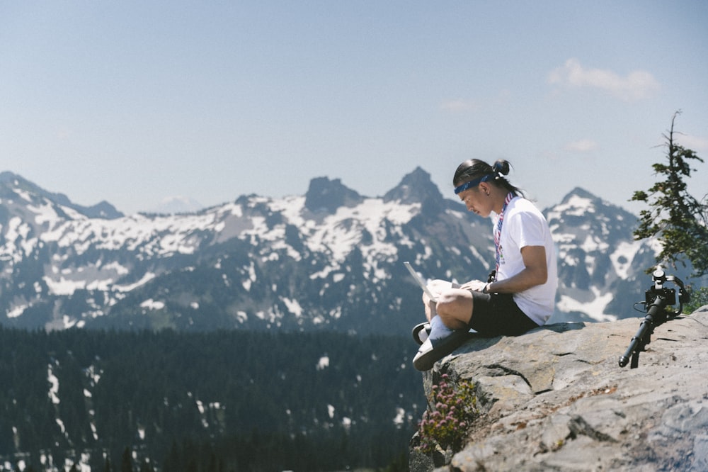 a man standing on top of a snow covered mountain