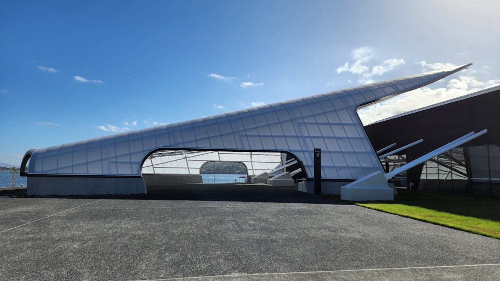 a large building with a curved roof on a sunny day