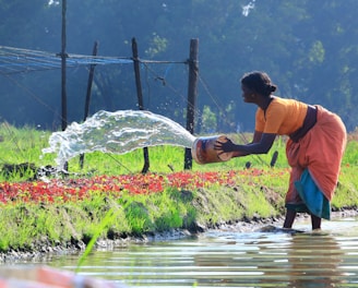 a woman watering water from a watering hose