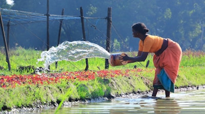 a woman watering water from a watering hose