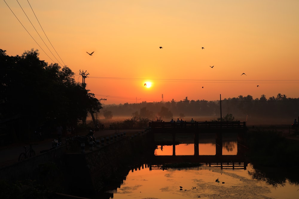 the sun is setting over a body of water