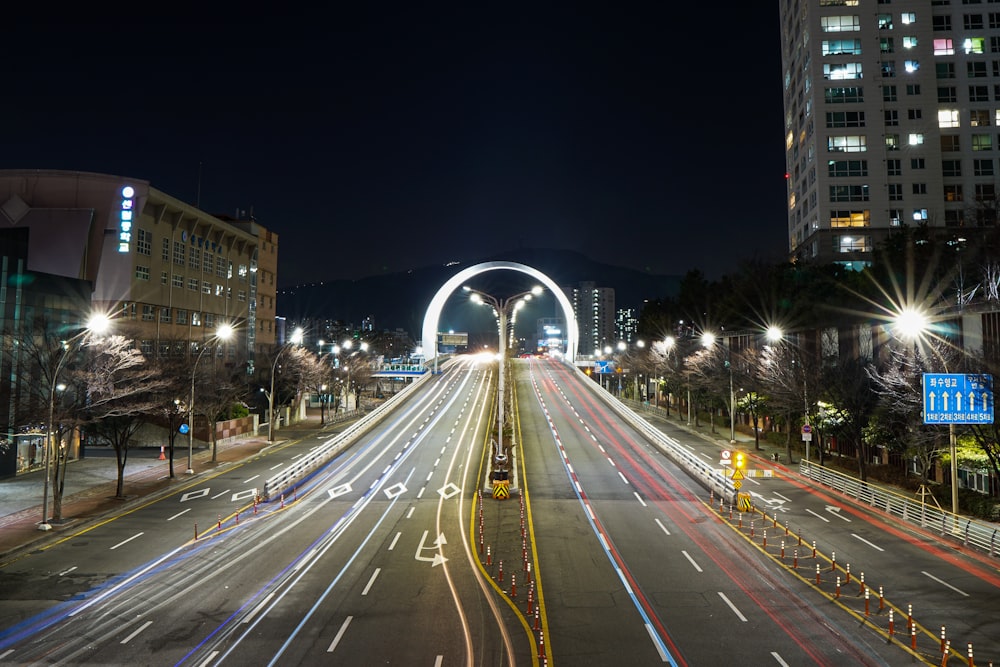 a city street filled with lots of traffic at night