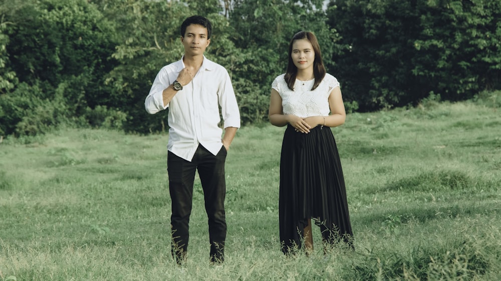 a man and a woman standing in a field