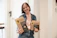 a woman holding three boxes of organic dog food