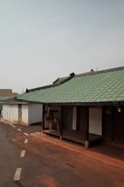 A serene villa with moving boxes neatly stacked outside, ready for transport.