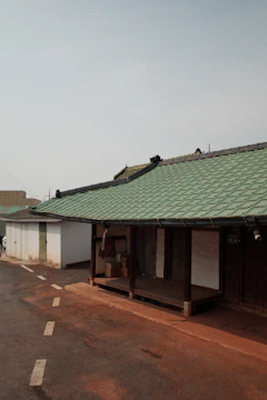 A serene villa with moving boxes neatly stacked outside, ready for transport.