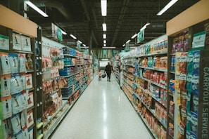 a person walking down a aisle in a grocery store