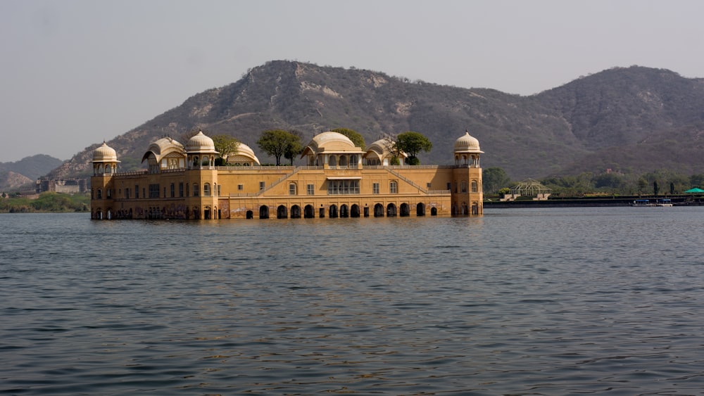 a large building sitting in the middle of a lake