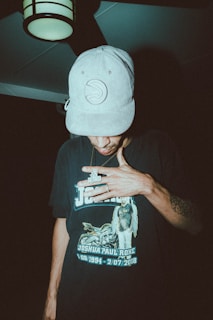 a man wearing a hat and smoking a cigarette