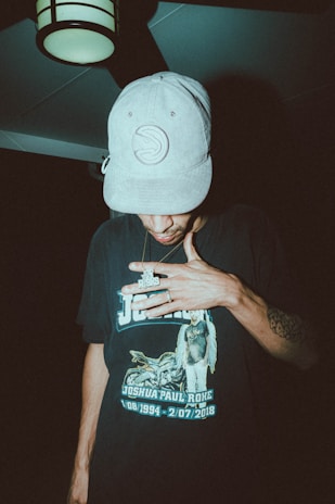 a man wearing a hat and smoking a cigarette