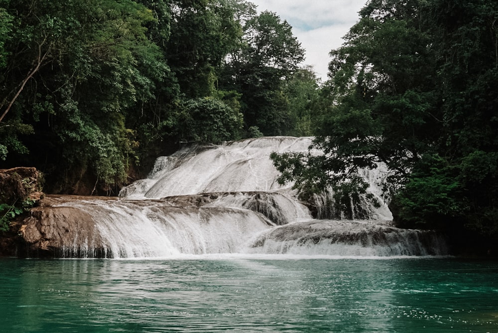 una cascada en medio de un cuerpo de agua