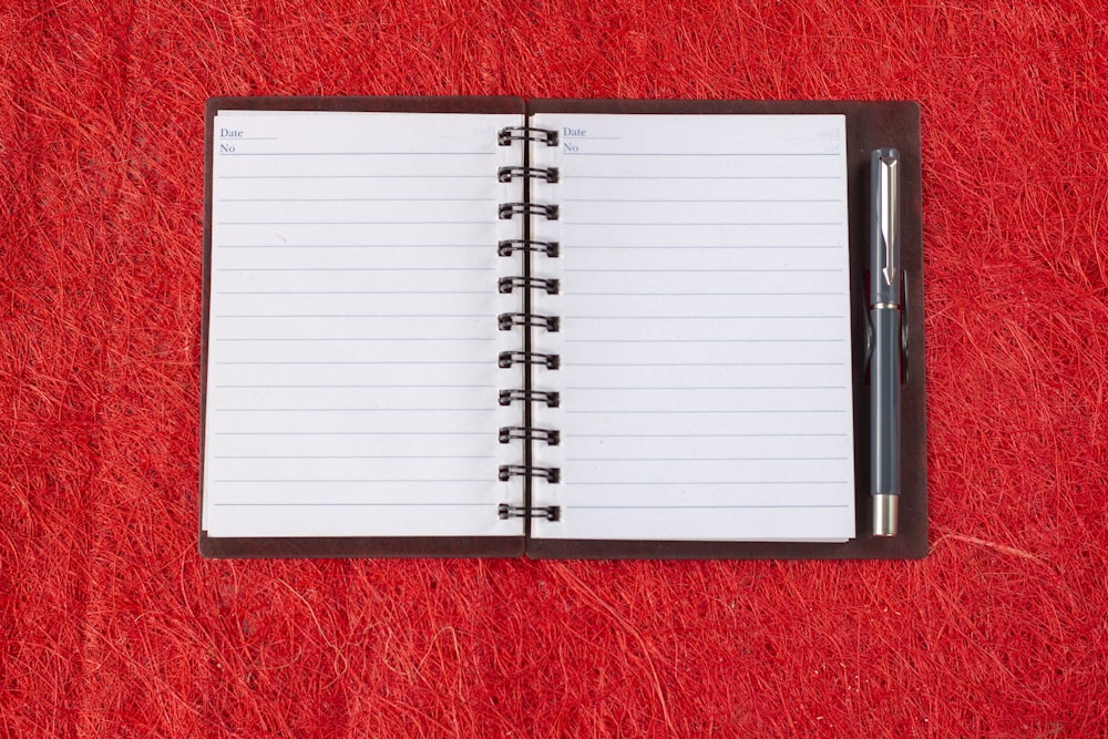 a notebook with a pen on top of it