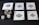 Five playing cards, all aces of spades, are arranged on a dark surface. Beside the cards, there is a stack of poker chips with two dice on top. Three additional dice are placed nearby, with both the poker chips and dice featuring a combination of red, blue, and white colors.
