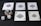 Five playing cards, all aces of spades, are arranged on a dark surface. Beside the cards, there is a stack of poker chips with two dice on top. Three additional dice are placed nearby, with both the poker chips and dice featuring a combination of red, blue, and white colors.