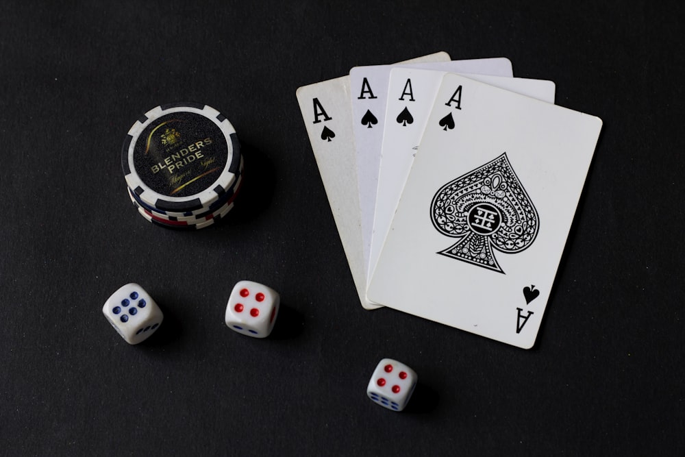 playing cards and dice on a black table