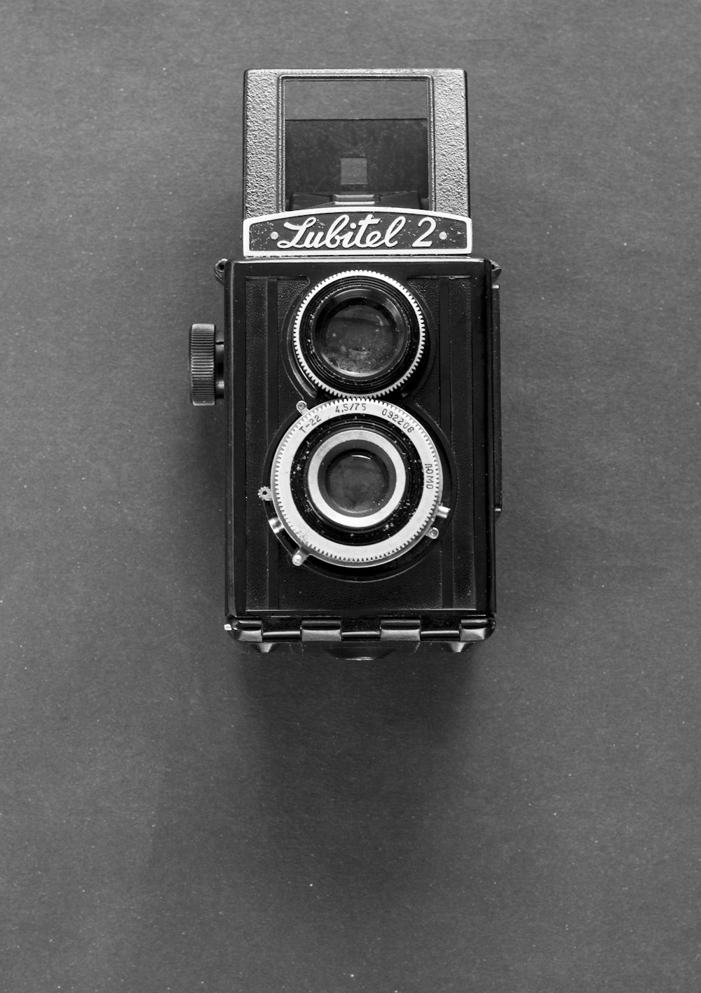 a black and white photo of an old camera