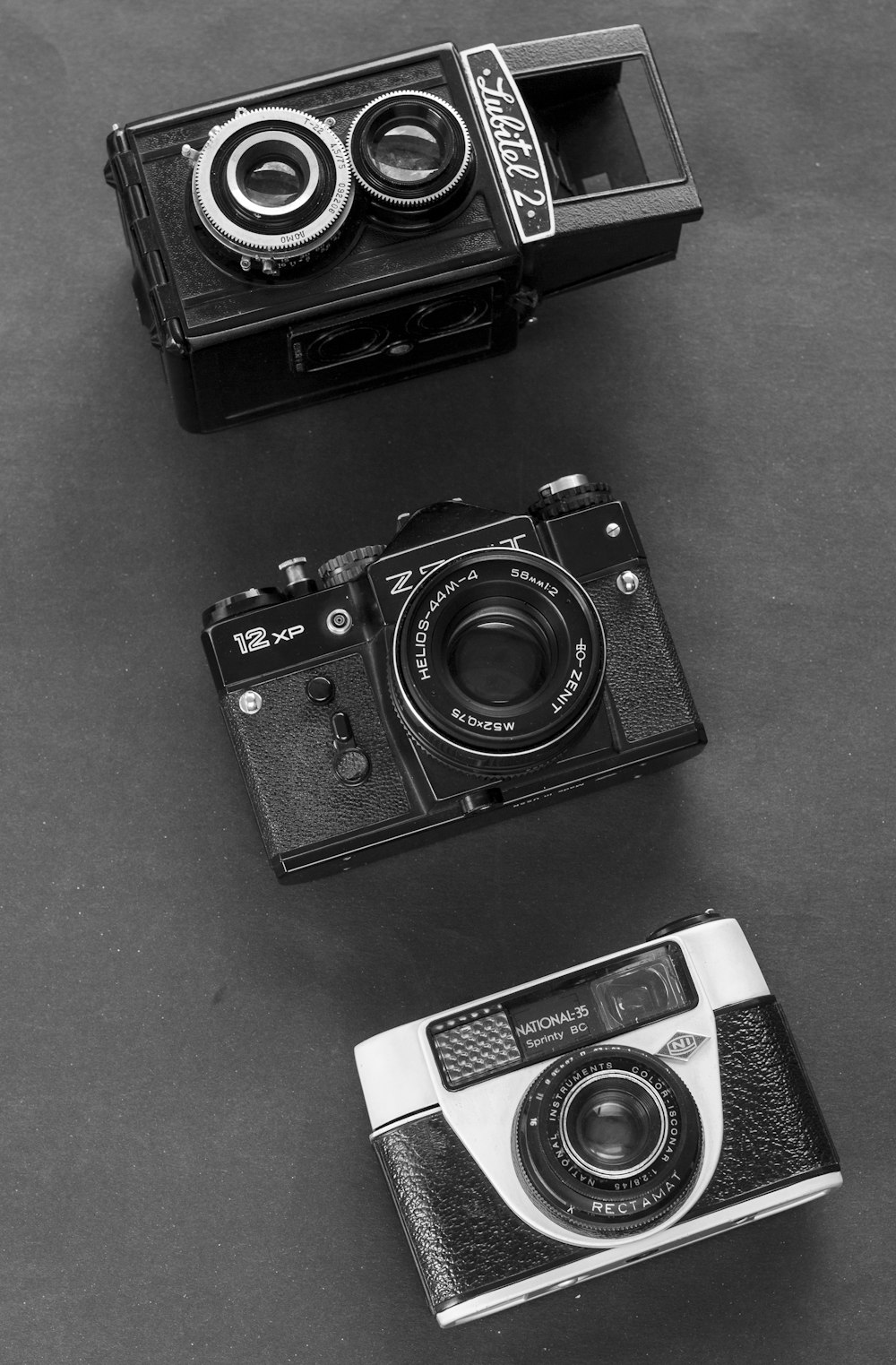 a couple of cameras sitting on top of a table