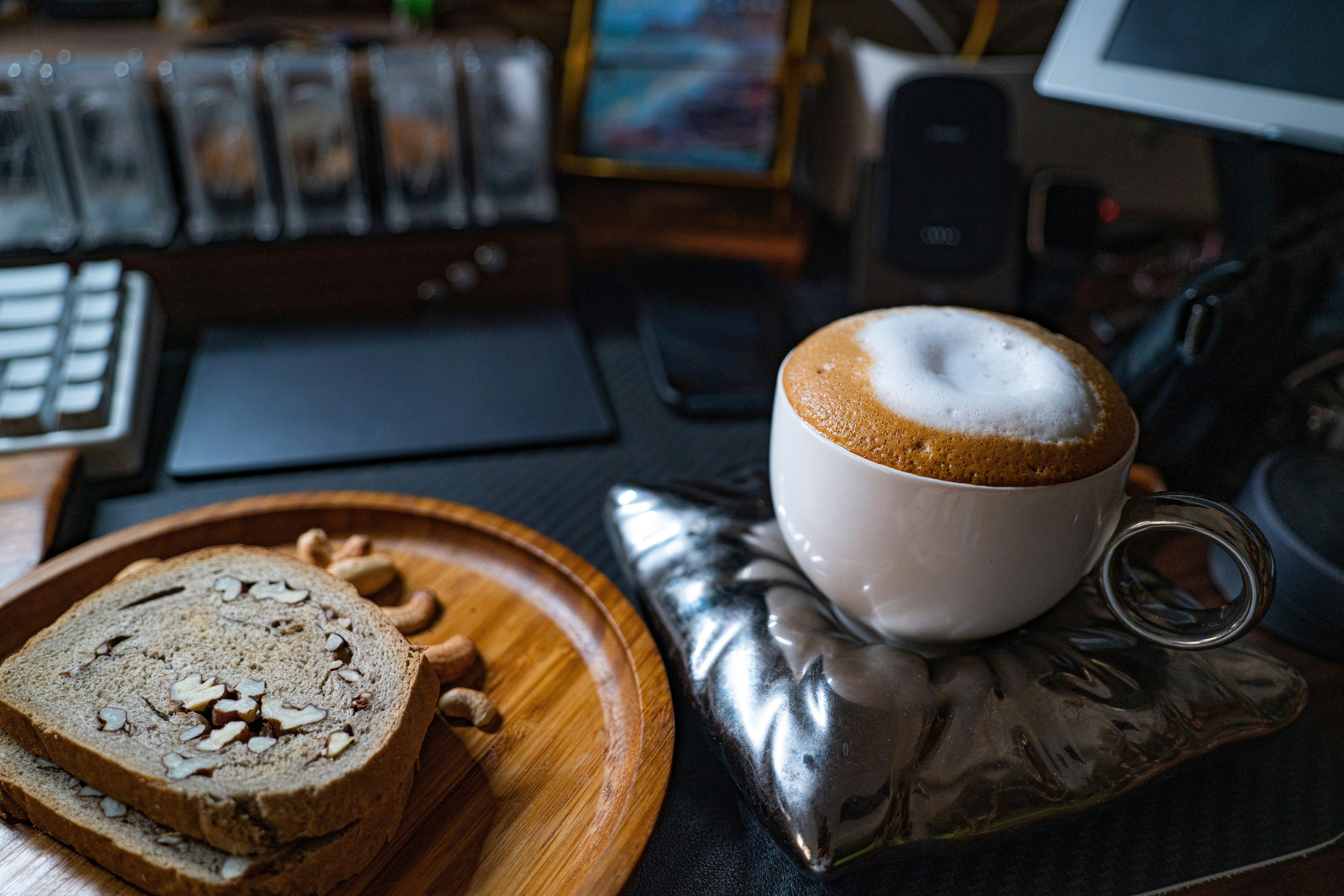 a cup of coffee and some bread on a table