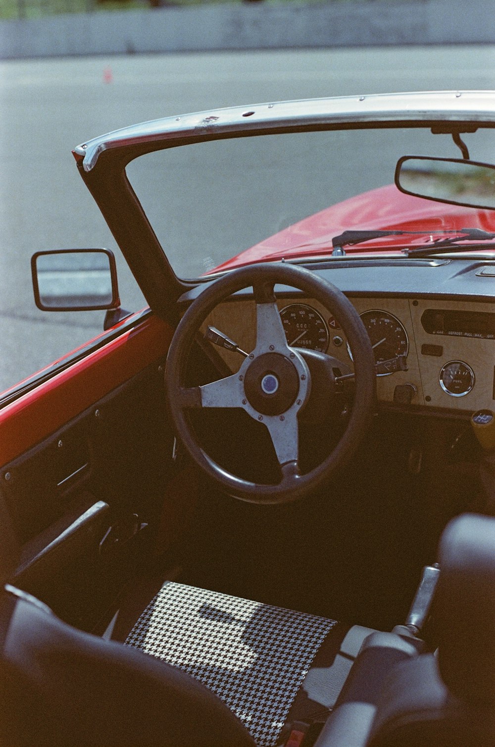 a red car with a steering wheel and dashboard