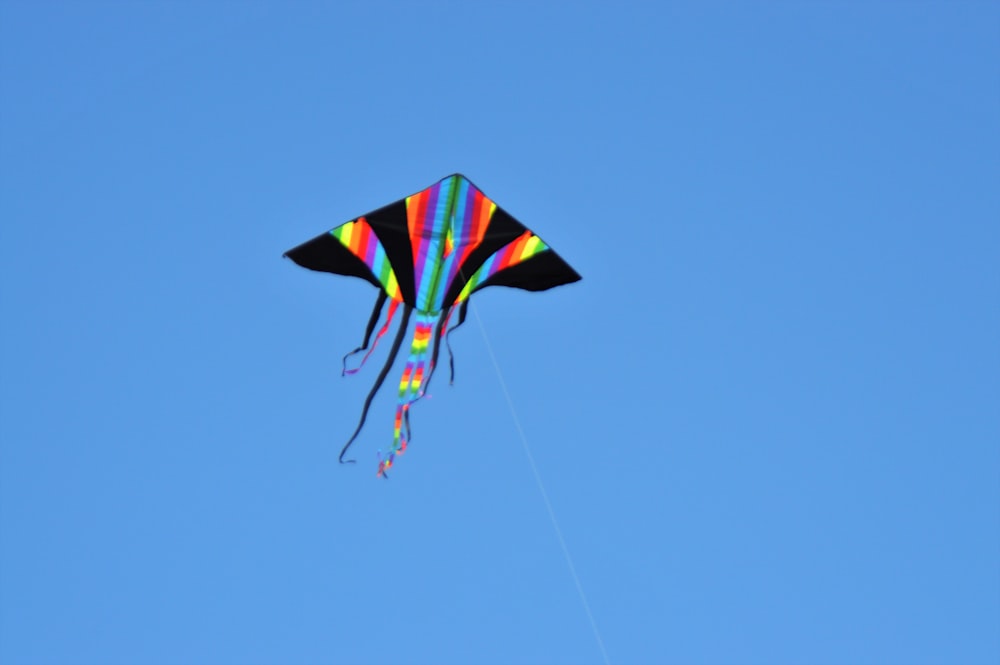 a colorful kite flying in a blue sky