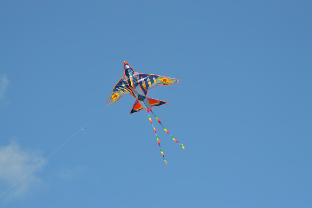 a colorful kite flying in a blue sky