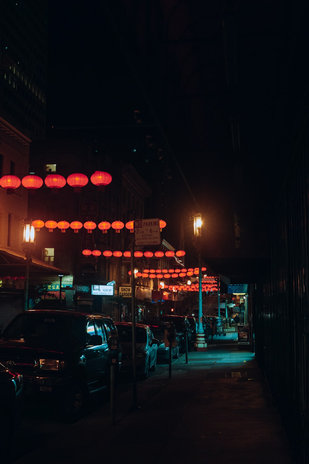 a dark city street at night with red lights