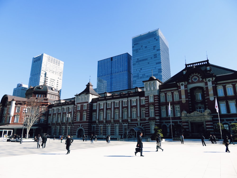 a group of people walking in front of a building