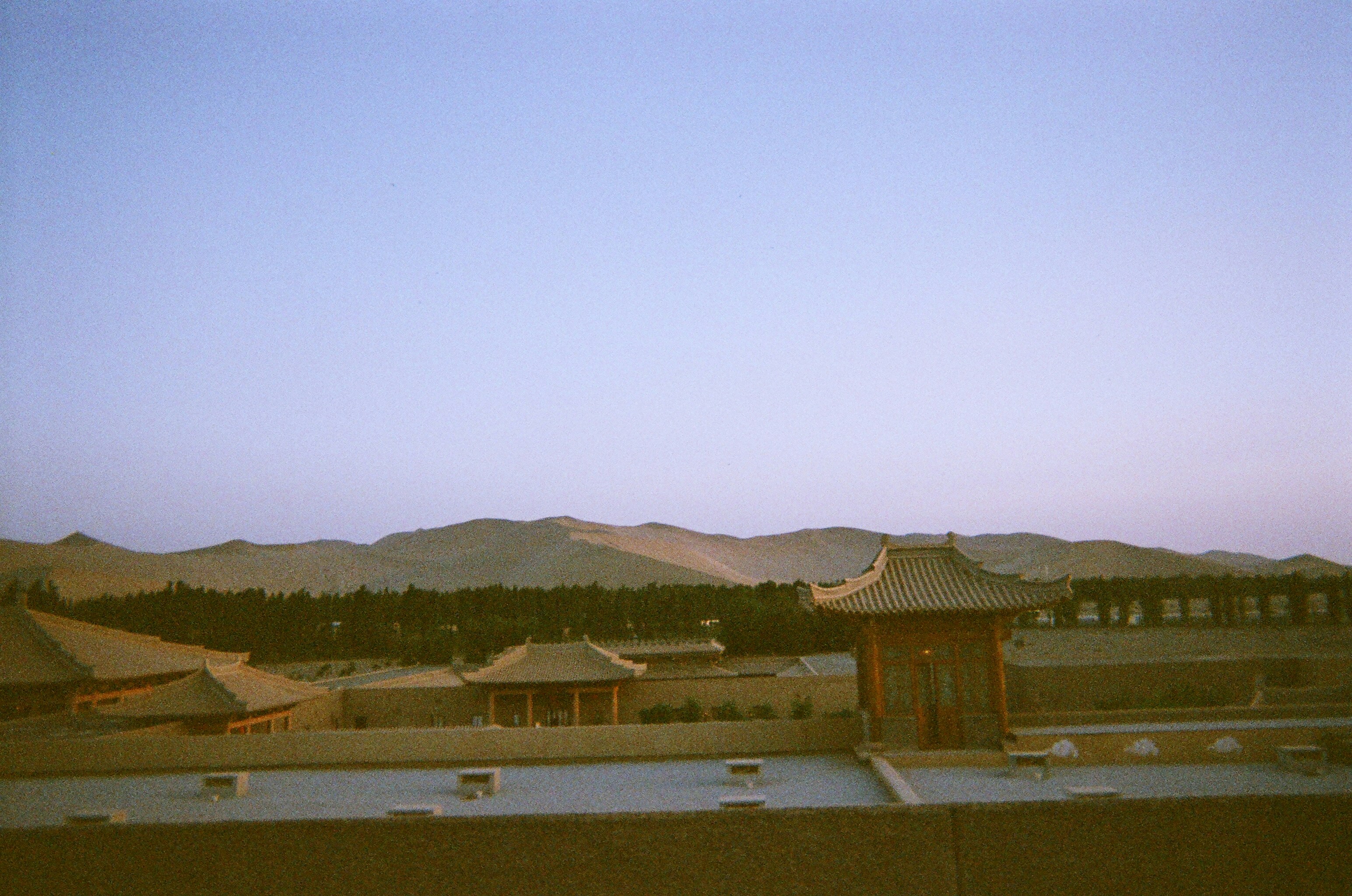 a view of a building with mountains in the background