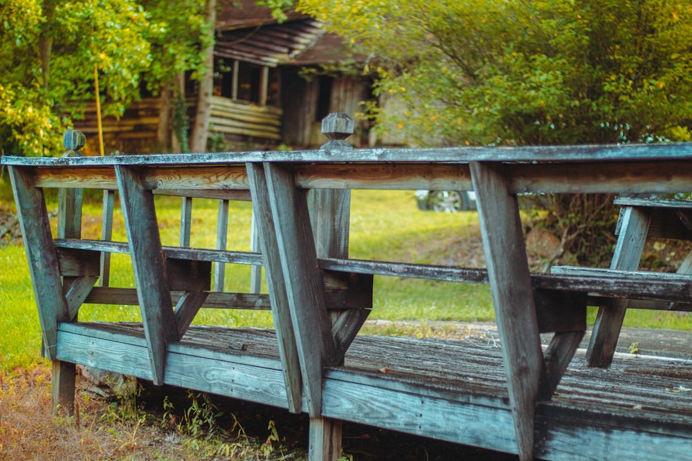 a wooden bench sitting on top of a lush green field