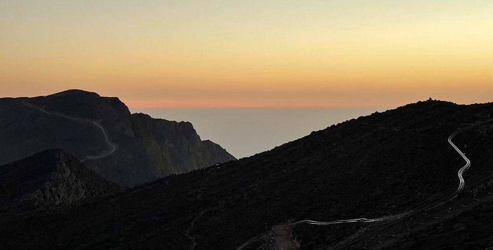 a mountain with a winding road in the middle of it