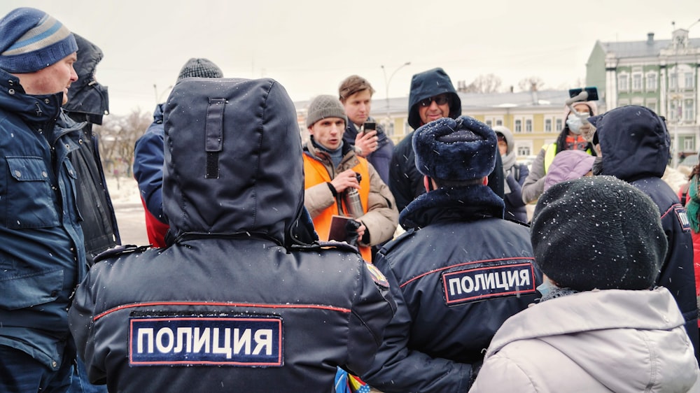 a group of people standing around each other