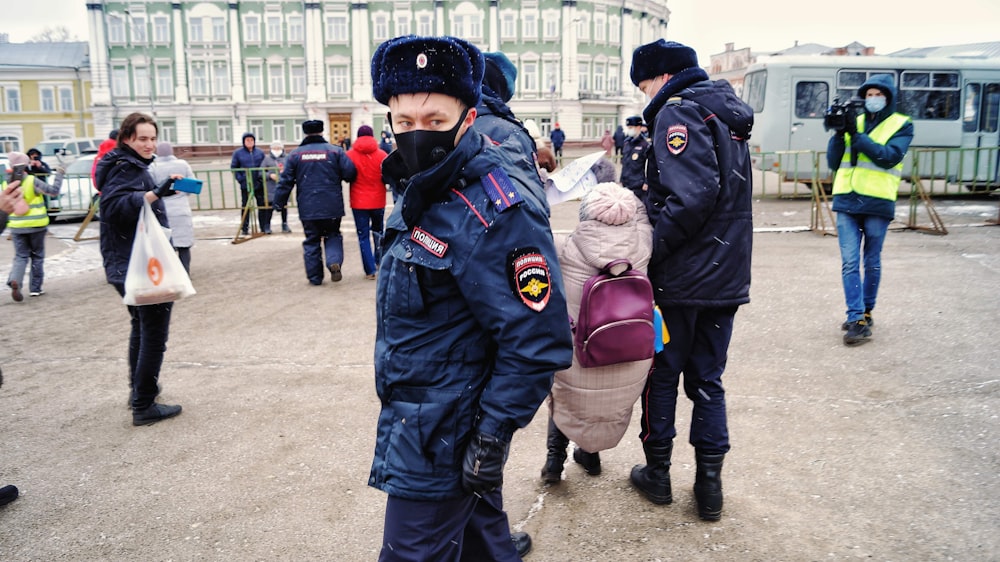 a man in a police uniform walking with a child