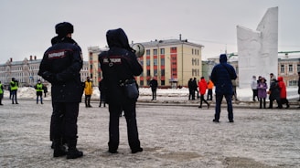 a couple of people that are standing in the snow