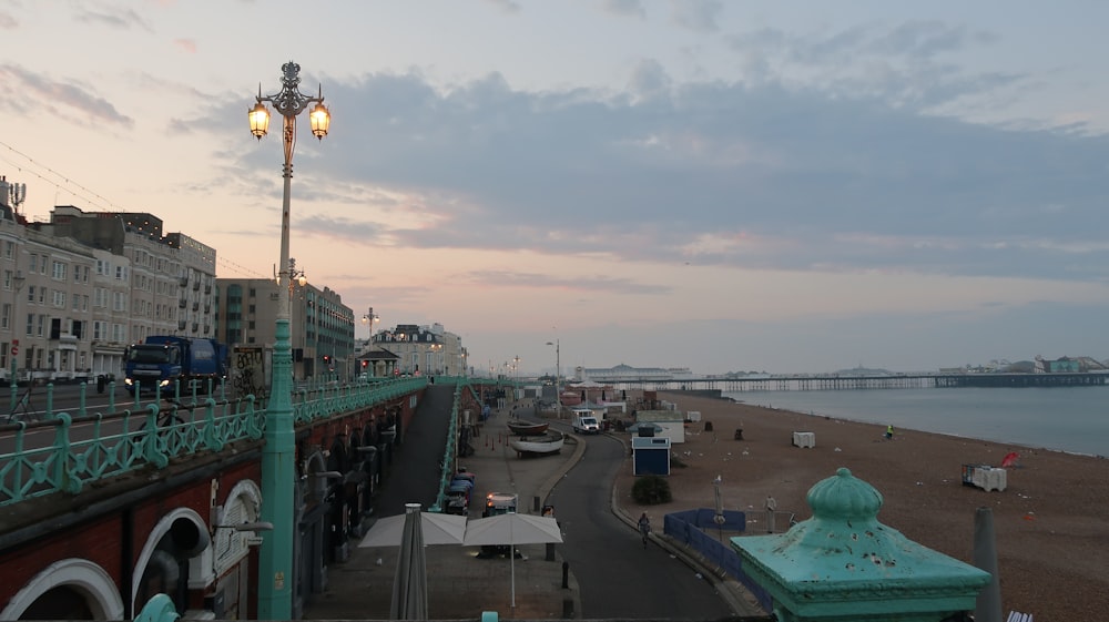 a view of a beach with a bridge in the background