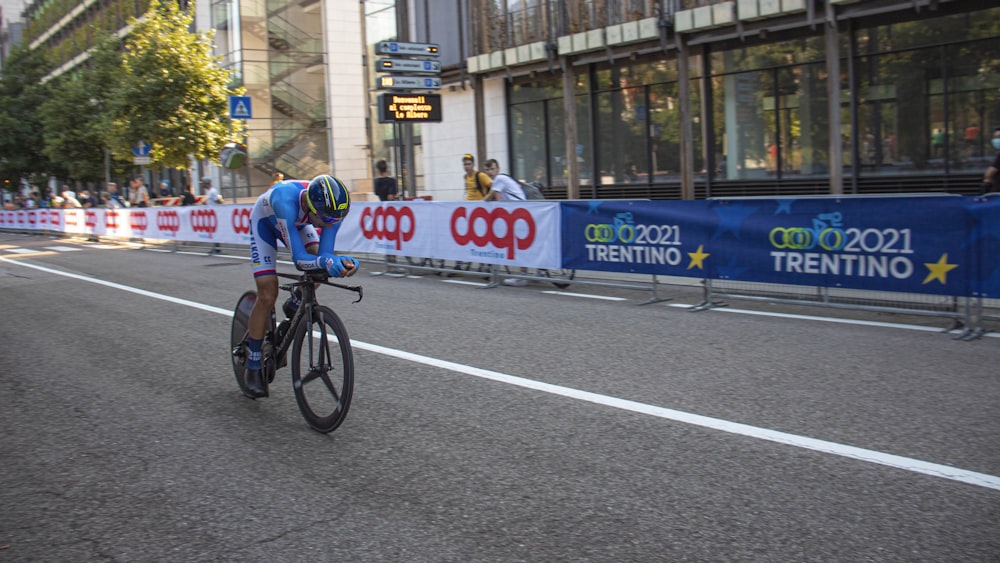 a man riding a bike down a street