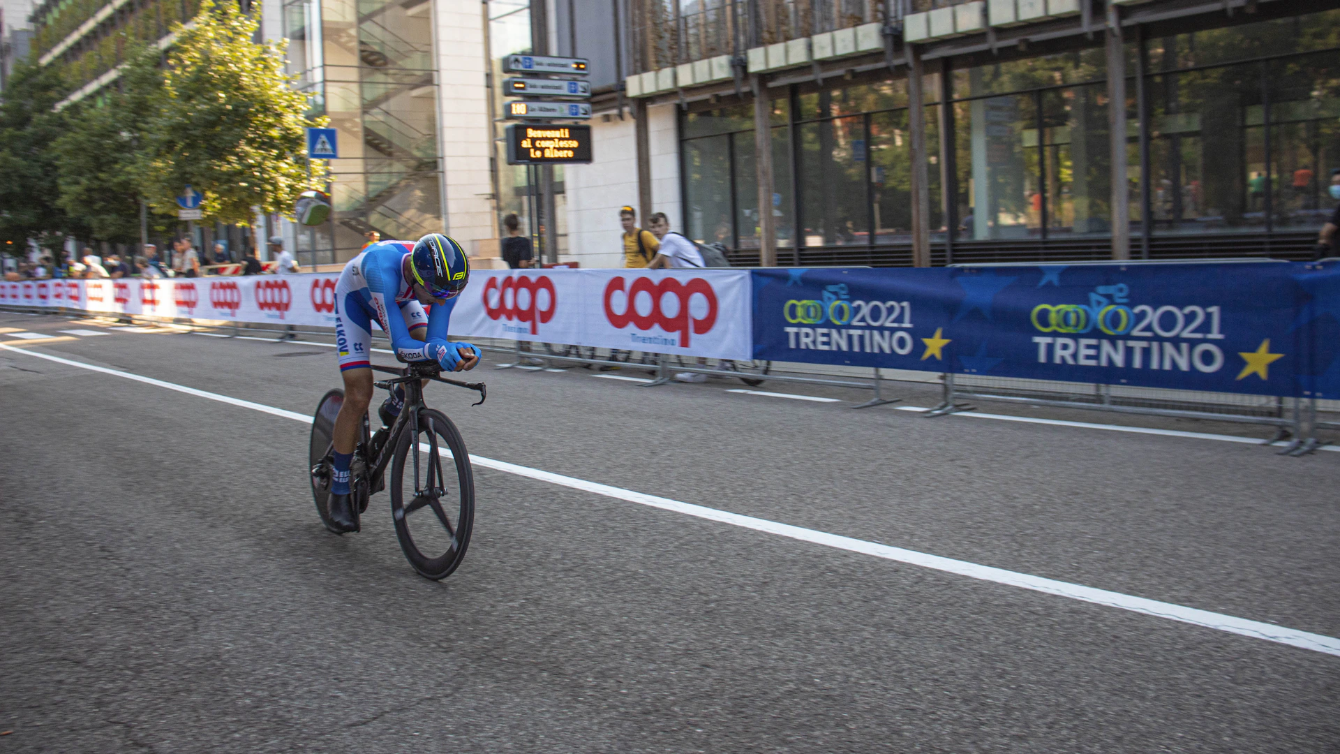 a man riding a bike down a street