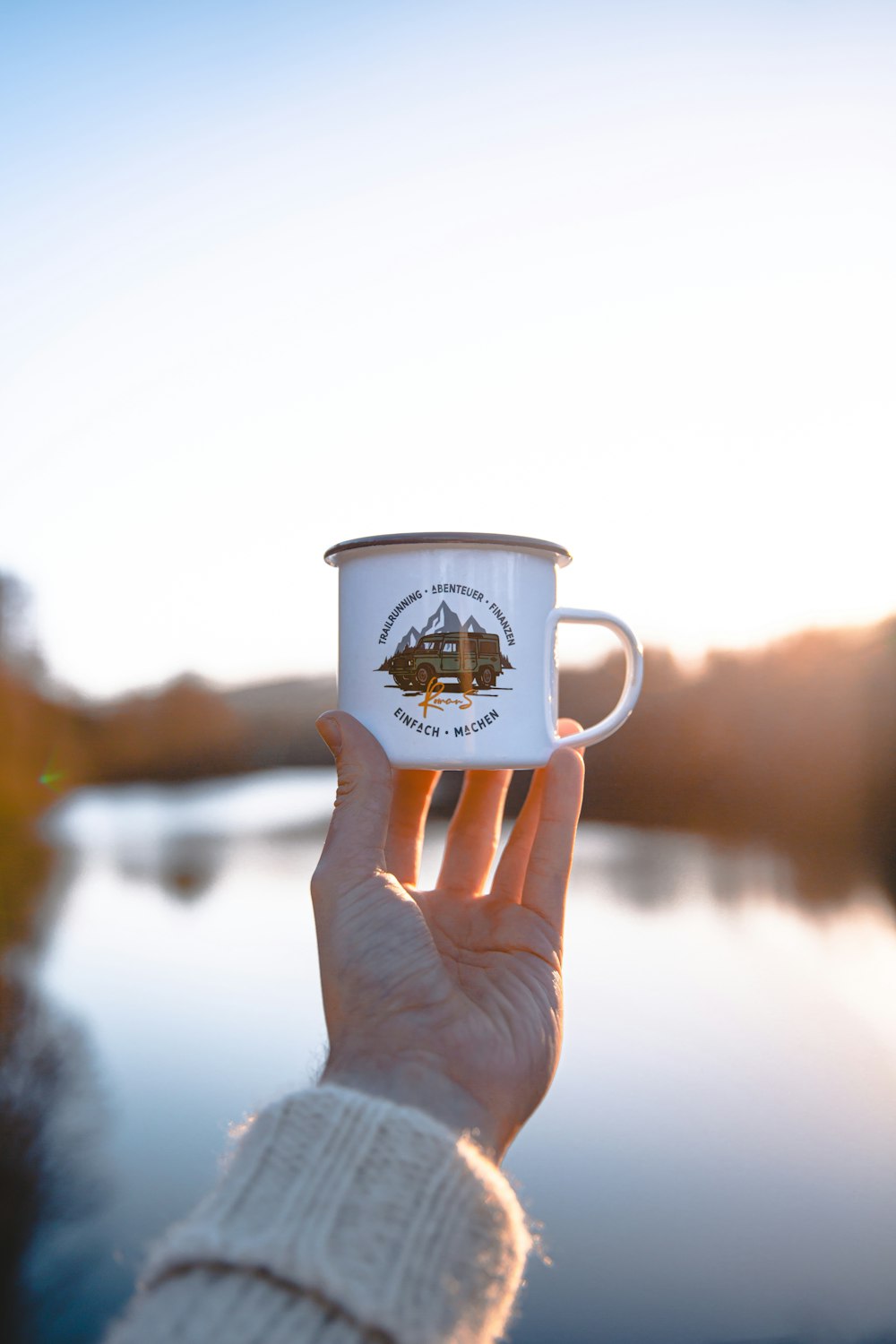 a person holding a coffee cup in their hand