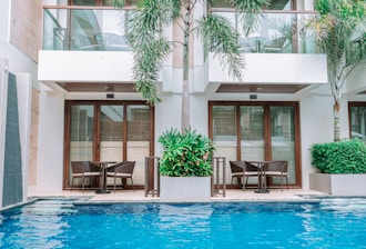 a hotel with a swimming pool and chairs