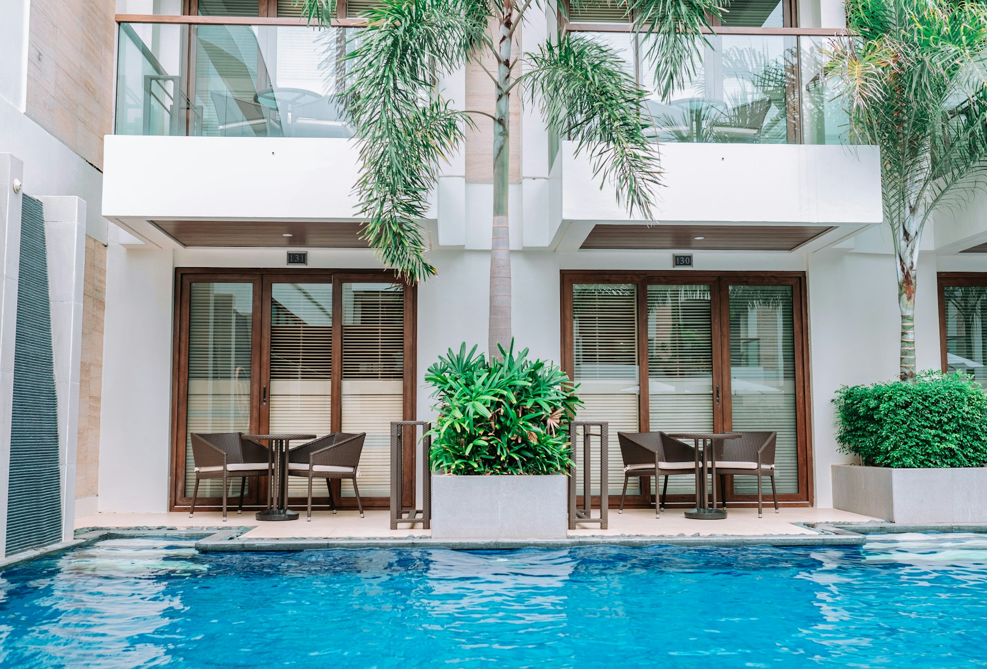 a hotel with a swimming pool and chairs