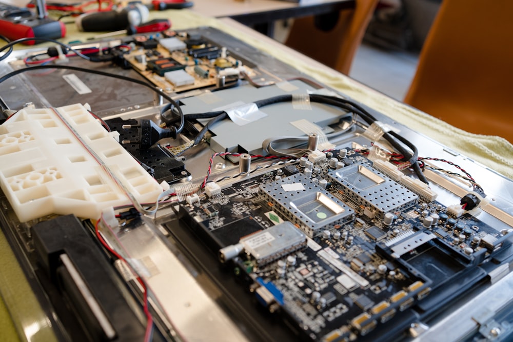 An Apple Mac being refurbished with the rear case removed.