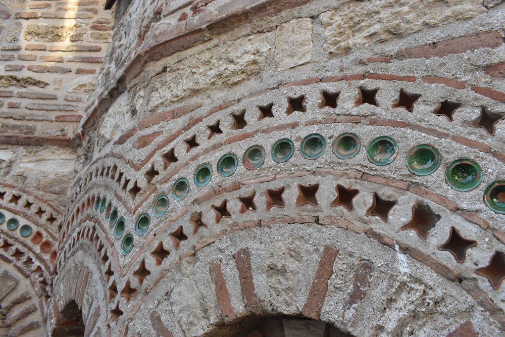 a close up of a building with a clock on the side of it