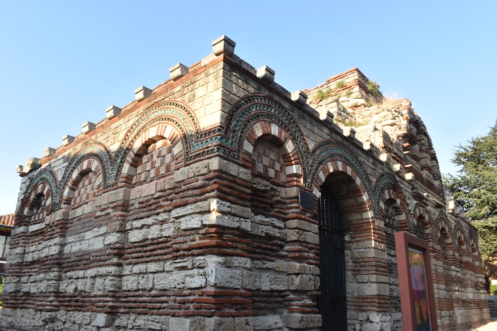 an old brick building with arched windows and a door