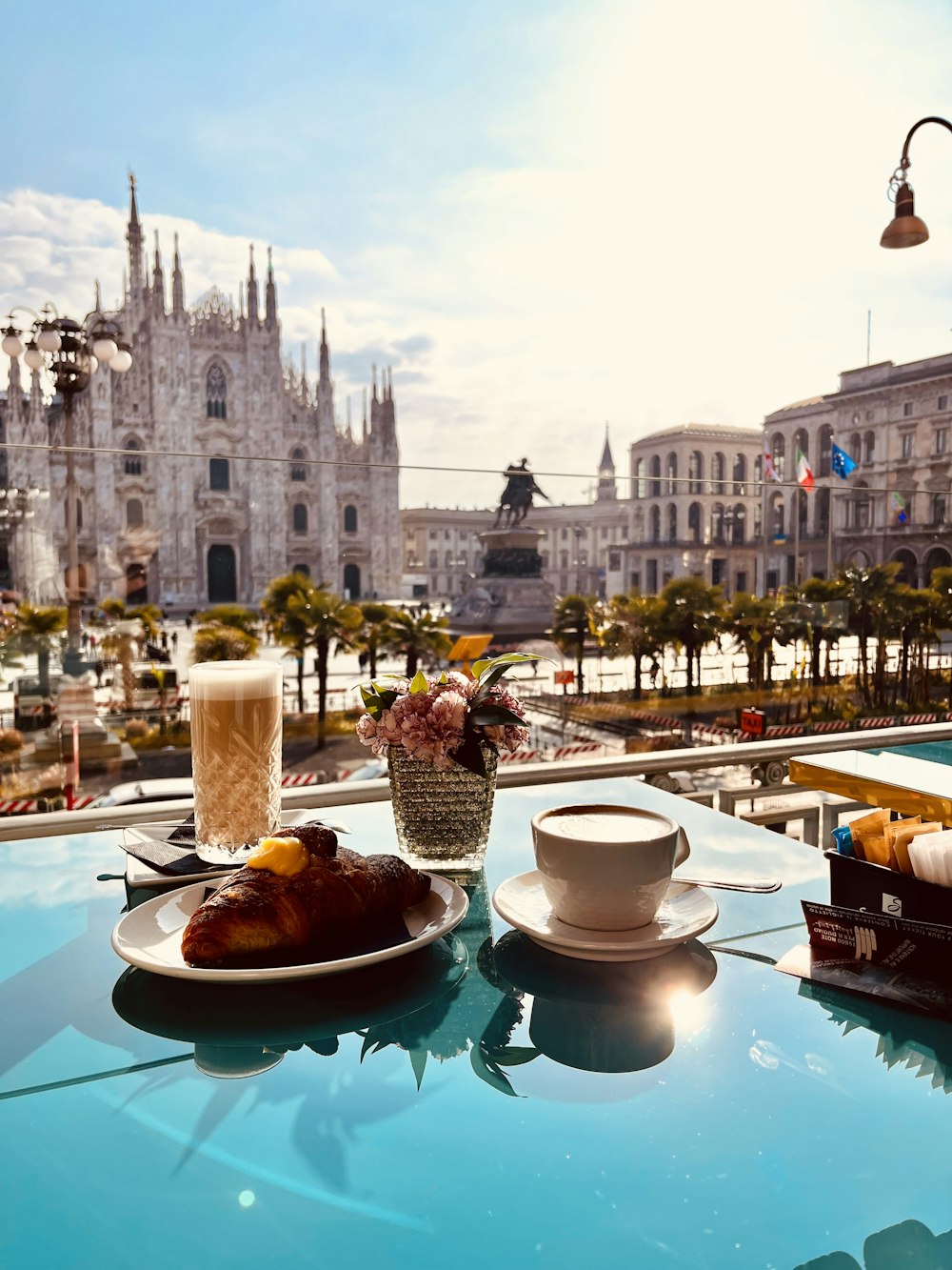 two plates of food on a table with a view of a city