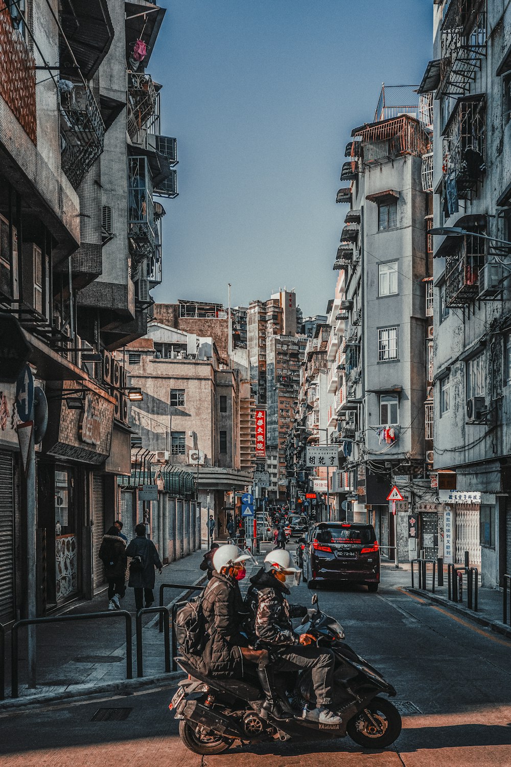 a group of people riding on the back of a motorcycle