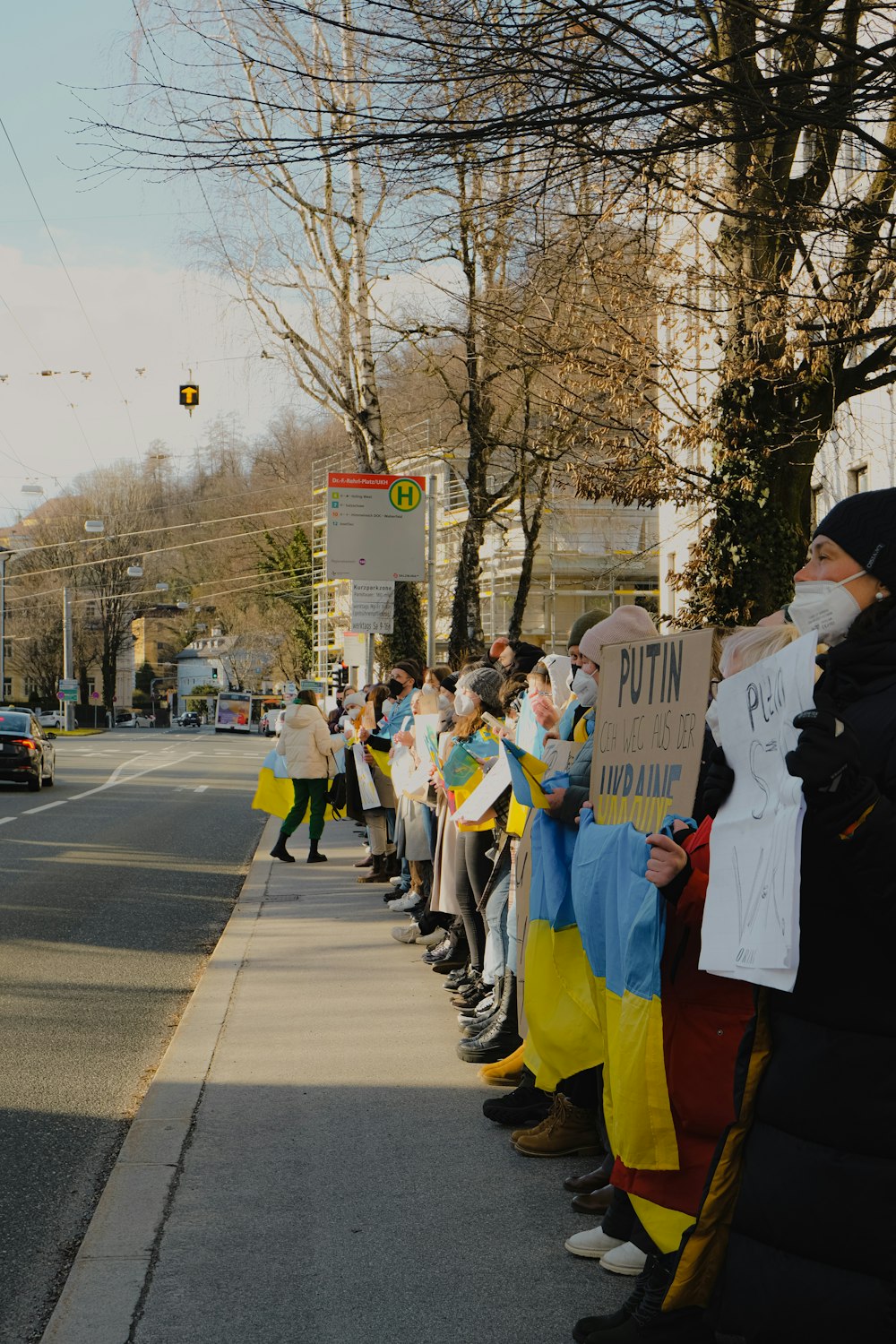 a group of people standing on the side of a road