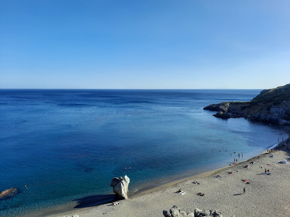 a beach with people on it and a body of water