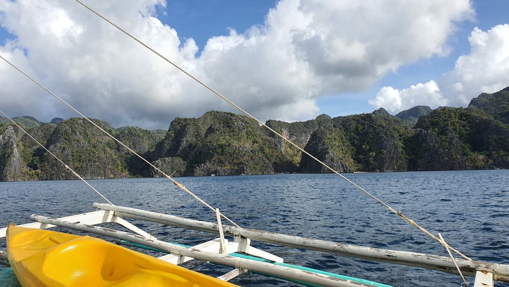 a yellow kayak sitting on top of a body of water