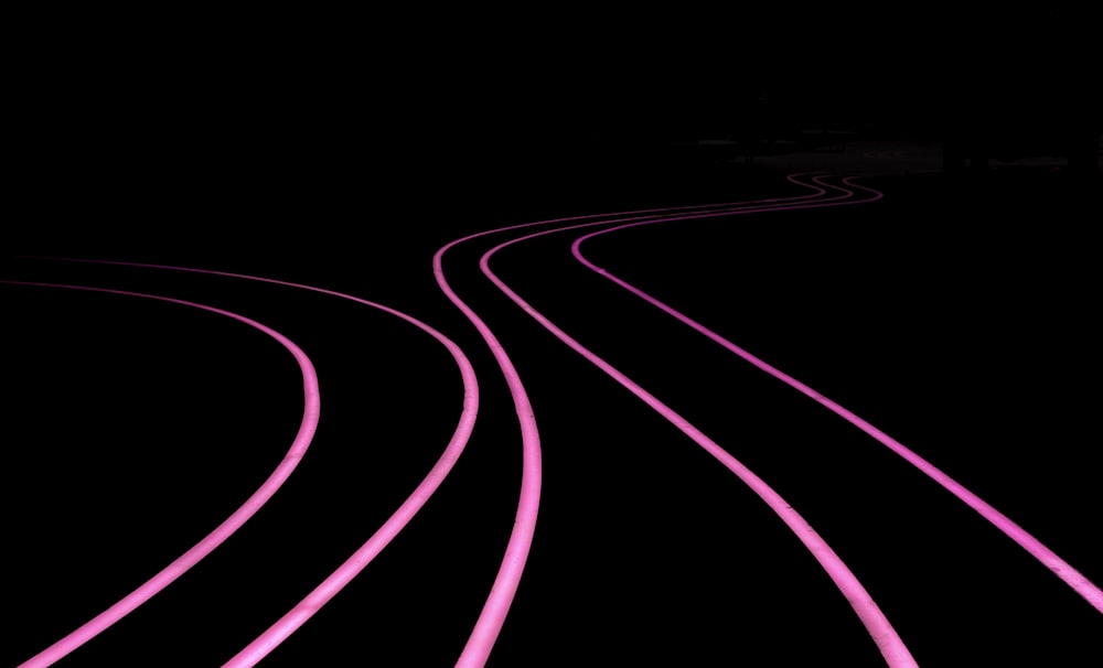 a black and pink photo of a train track