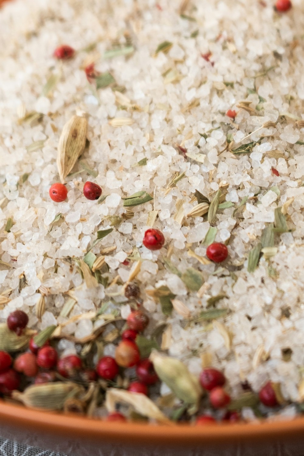 a bowl filled with rice and cranberries on top of a table